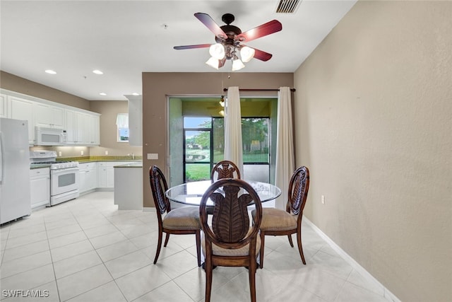 dining area featuring ceiling fan and light tile patterned floors