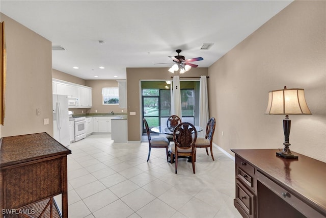 dining area featuring ceiling fan and light tile patterned floors