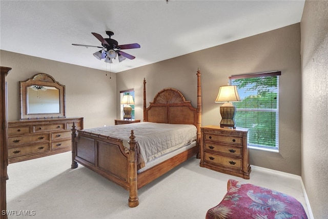 bedroom with light colored carpet and ceiling fan