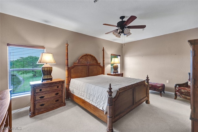 bedroom featuring ceiling fan and light carpet