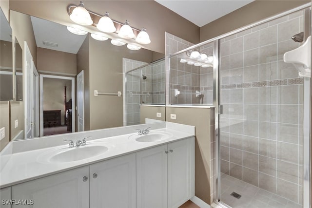 bathroom featuring vanity and a shower with shower door