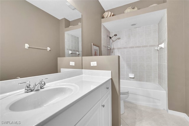 full bathroom with tile patterned flooring, tiled shower / bath combo, vanity, and toilet