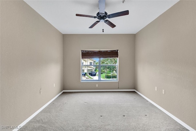 unfurnished room with ceiling fan and carpet flooring