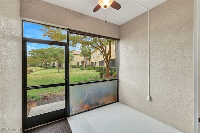 unfurnished sunroom with ceiling fan and a wealth of natural light