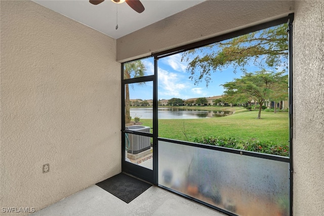 interior space featuring ceiling fan and a water view