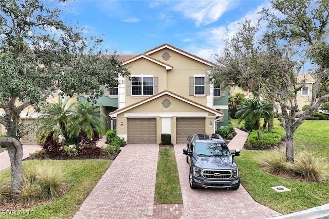 view of front of property featuring a front yard and a garage