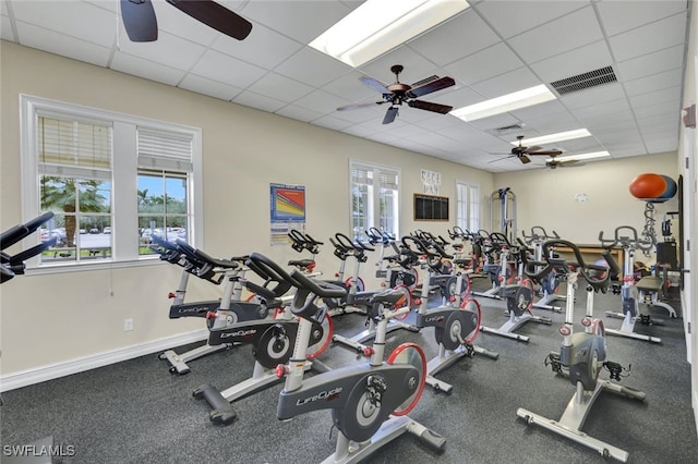 gym with a paneled ceiling