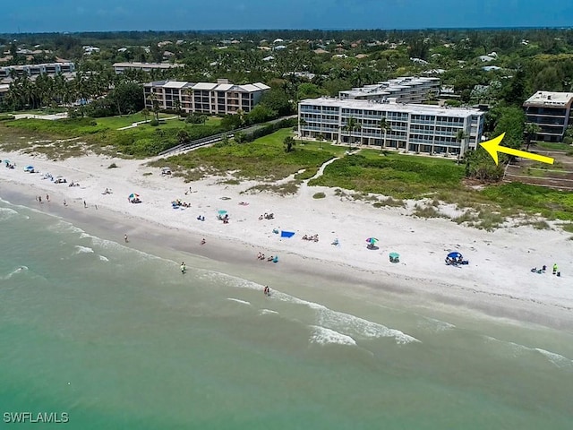 bird's eye view featuring a water view and a beach view