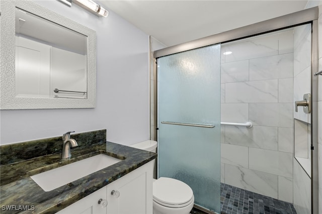 bathroom featuring walk in shower, vanity, and toilet