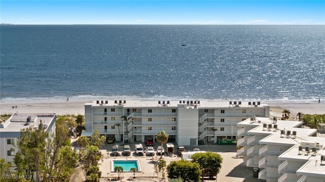 drone / aerial view with a beach view and a water view