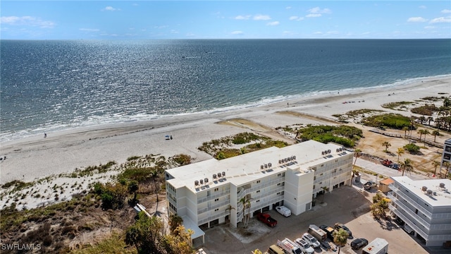 drone / aerial view featuring a beach view and a water view