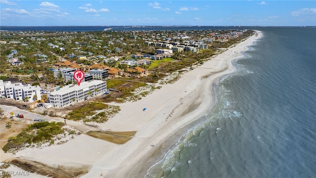 drone / aerial view with a water view and a beach view