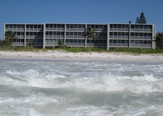 view of building exterior featuring a beach view