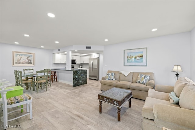 living room with light hardwood / wood-style floors