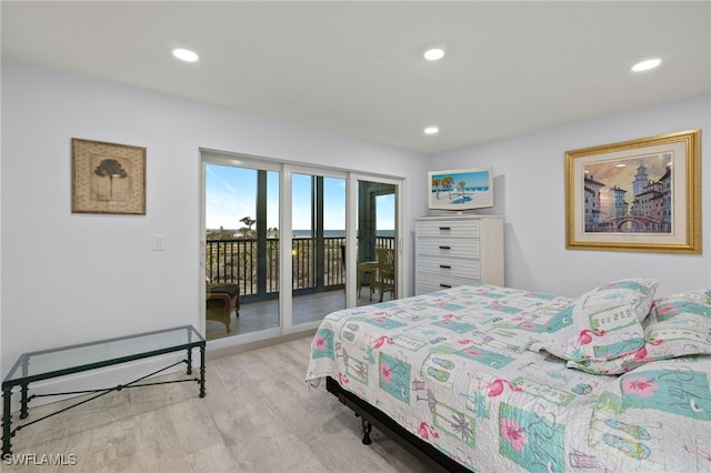 bedroom with light hardwood / wood-style floors and access to outside