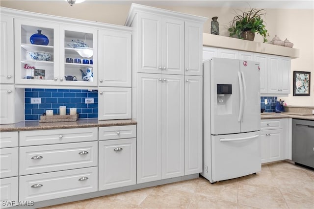 kitchen featuring stainless steel dishwasher, white cabinets, decorative backsplash, and white fridge with ice dispenser