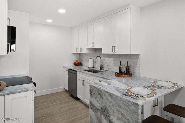 342 Harbour Dr, Naples, FL 34103 - kitchen with a peninsula, baseboards, white cabinets, a sink, and dishwasher