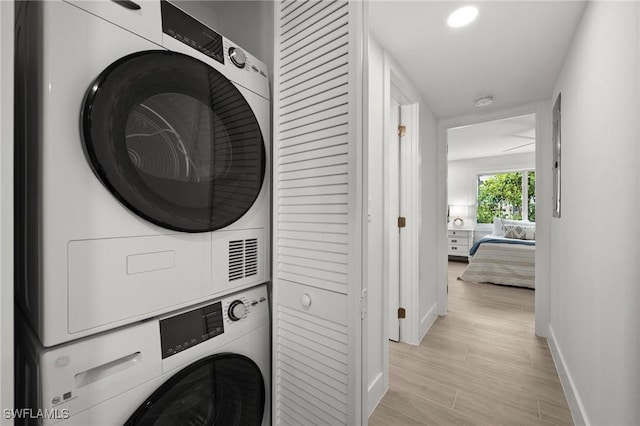 clothes washing area featuring stacked washer / drying machine