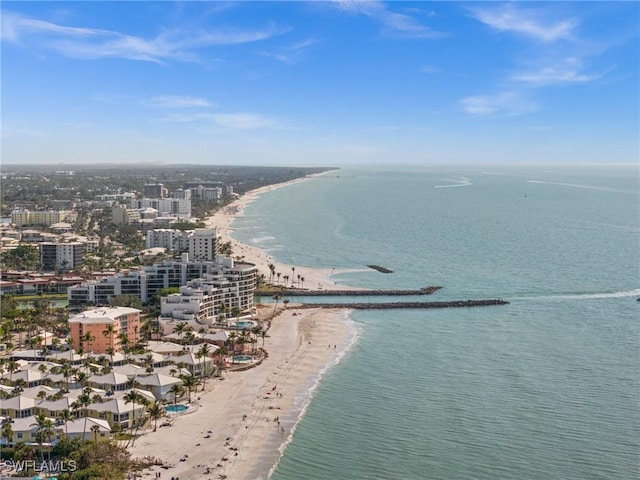 bird's eye view featuring a water view and a beach view