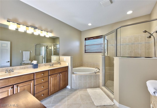 bathroom featuring independent shower and bath, vanity, and tile patterned floors