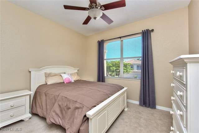 bedroom with ceiling fan and light carpet