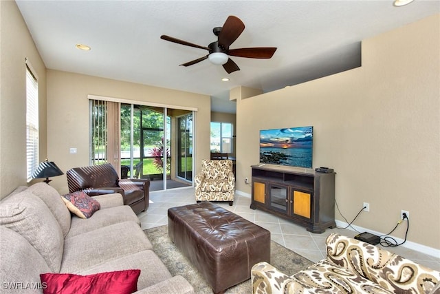 living room with ceiling fan and light tile patterned flooring