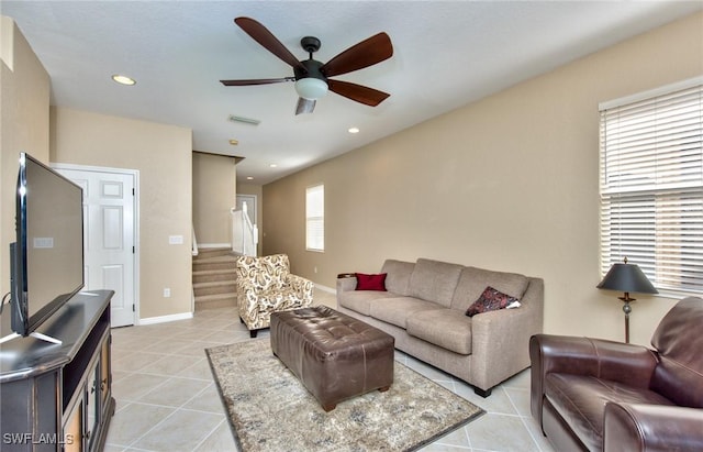 tiled living room featuring ceiling fan and a wealth of natural light