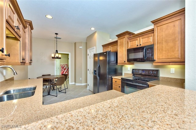 kitchen featuring black appliances, hanging light fixtures, light tile patterned flooring, and sink