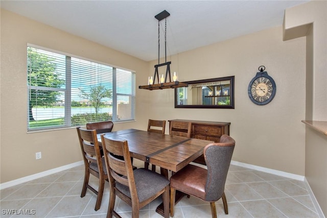 dining room featuring a chandelier and light tile patterned floors