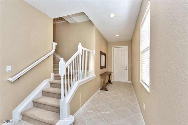 stairs featuring tile patterned flooring