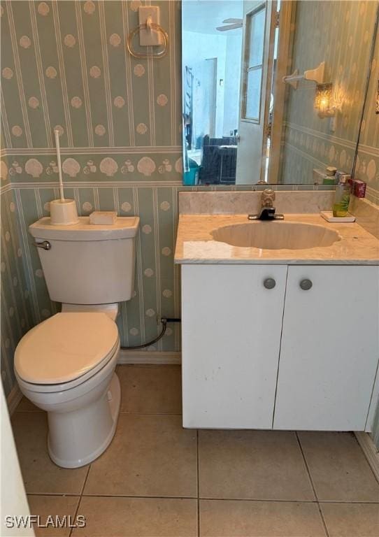 bathroom featuring toilet, vanity, and tile patterned floors