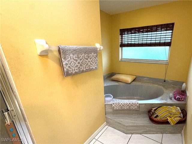 bathroom with a tub and tile patterned floors