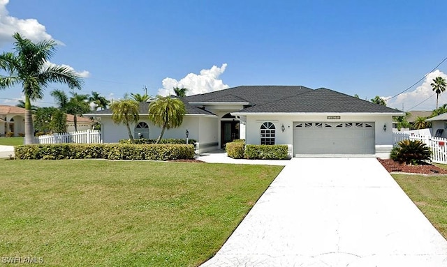 ranch-style house featuring a garage and a front yard