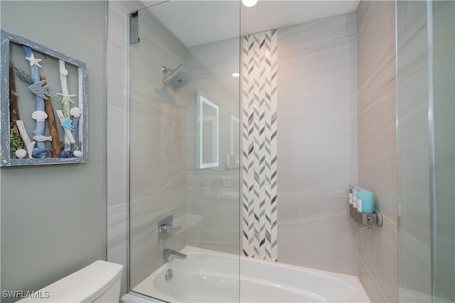 bathroom featuring toilet and tiled shower / bath combo