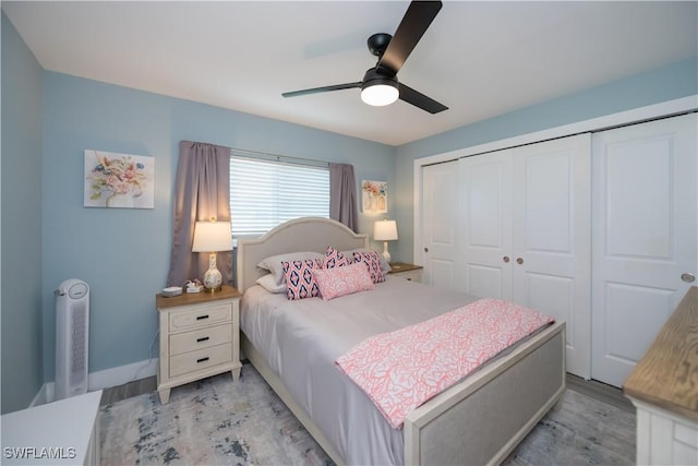 bedroom with ceiling fan, a closet, and light hardwood / wood-style flooring