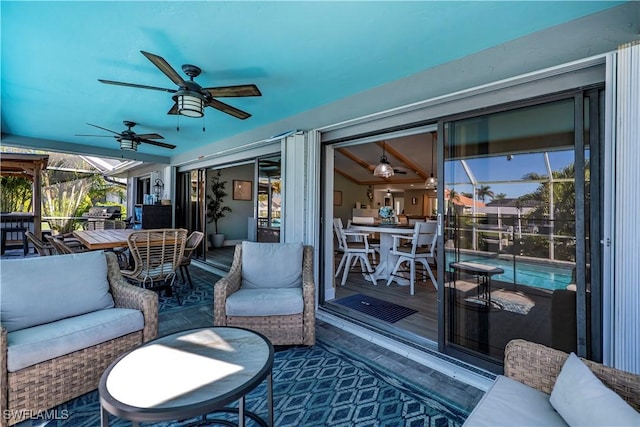 view of patio / terrace featuring ceiling fan, outdoor lounge area, and glass enclosure