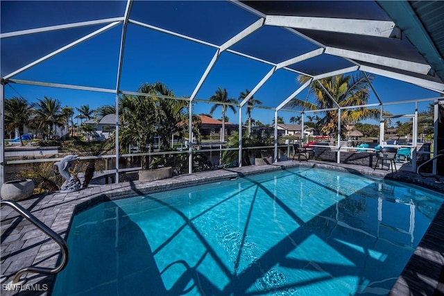 view of swimming pool with a lanai and a patio