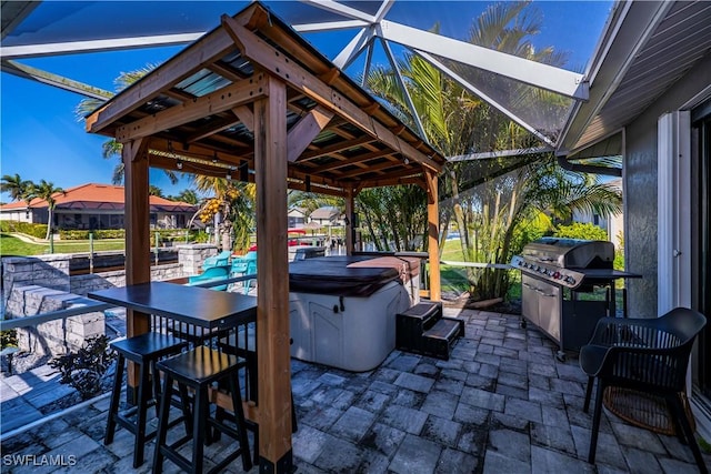 view of patio / terrace featuring grilling area, a hot tub, and a lanai