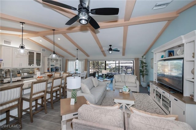 living room with lofted ceiling with beams