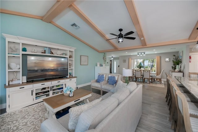 living room with vaulted ceiling with beams, light hardwood / wood-style floors, and ceiling fan