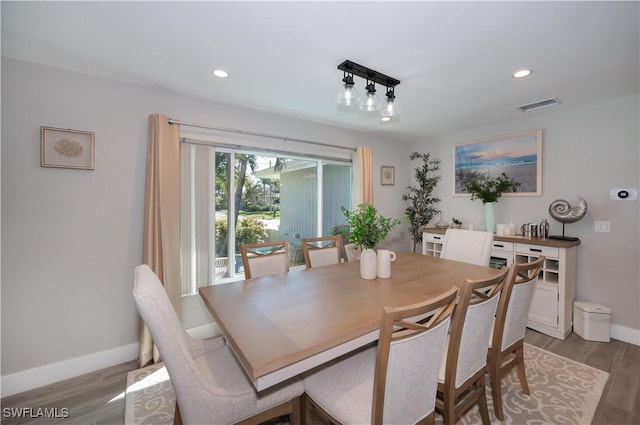 dining room with track lighting and light hardwood / wood-style floors