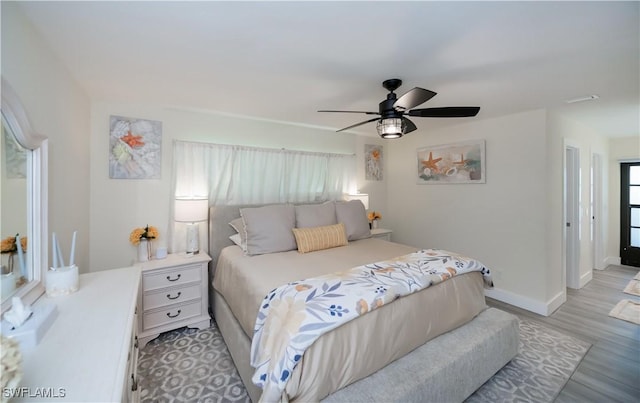 bedroom with ceiling fan and light hardwood / wood-style floors