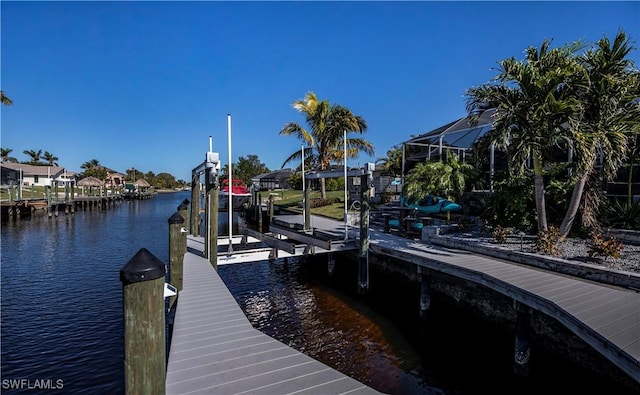 dock area with a lanai and a water view