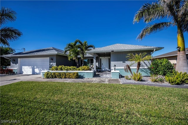 ranch-style home featuring a garage and a front lawn