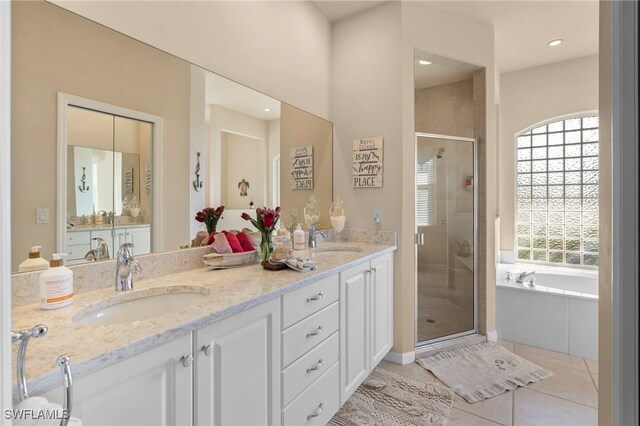 bathroom with tile patterned floors, vanity, and separate shower and tub