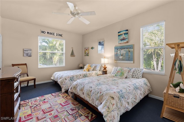 bedroom with ceiling fan and dark carpet