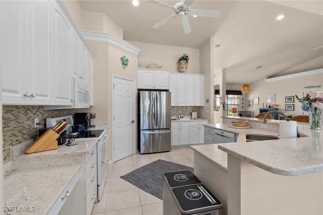 kitchen featuring decorative backsplash, appliances with stainless steel finishes, light tile patterned floors, white cabinetry, and lofted ceiling