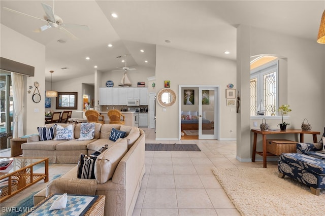 living room with high vaulted ceiling, ceiling fan, and light tile patterned flooring