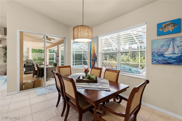 dining space featuring ceiling fan, light tile patterned flooring, and lofted ceiling