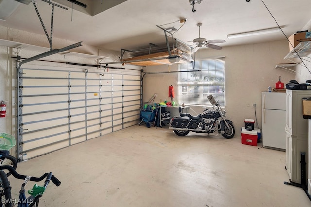 garage with white fridge, a garage door opener, and ceiling fan